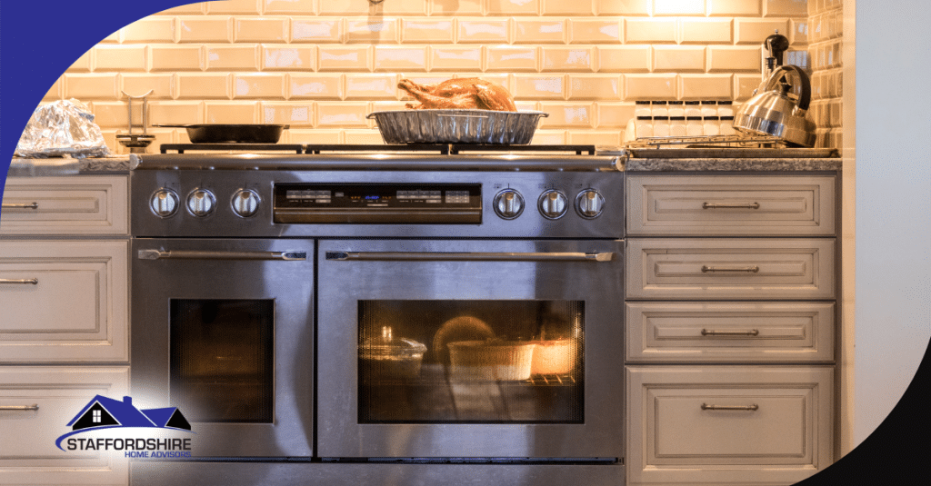 Roasted turkey resting on a stove with dishes baking inside the oven in a well-lit kitchen.